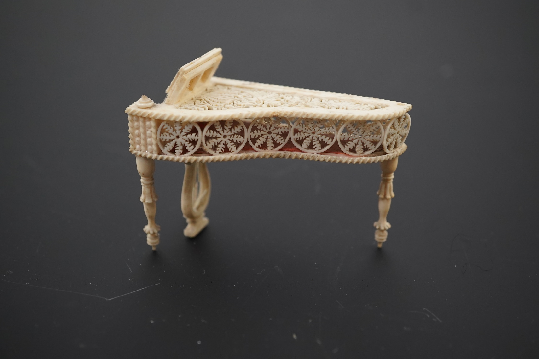 A Napoleonic Prisoner of War bone miniature model of a harpsichord, 6.5cm long. Condition - good